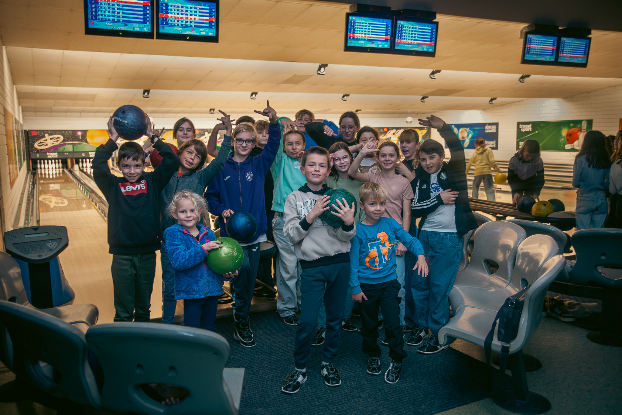 A woman holding a bowling ball with a group of people smiling